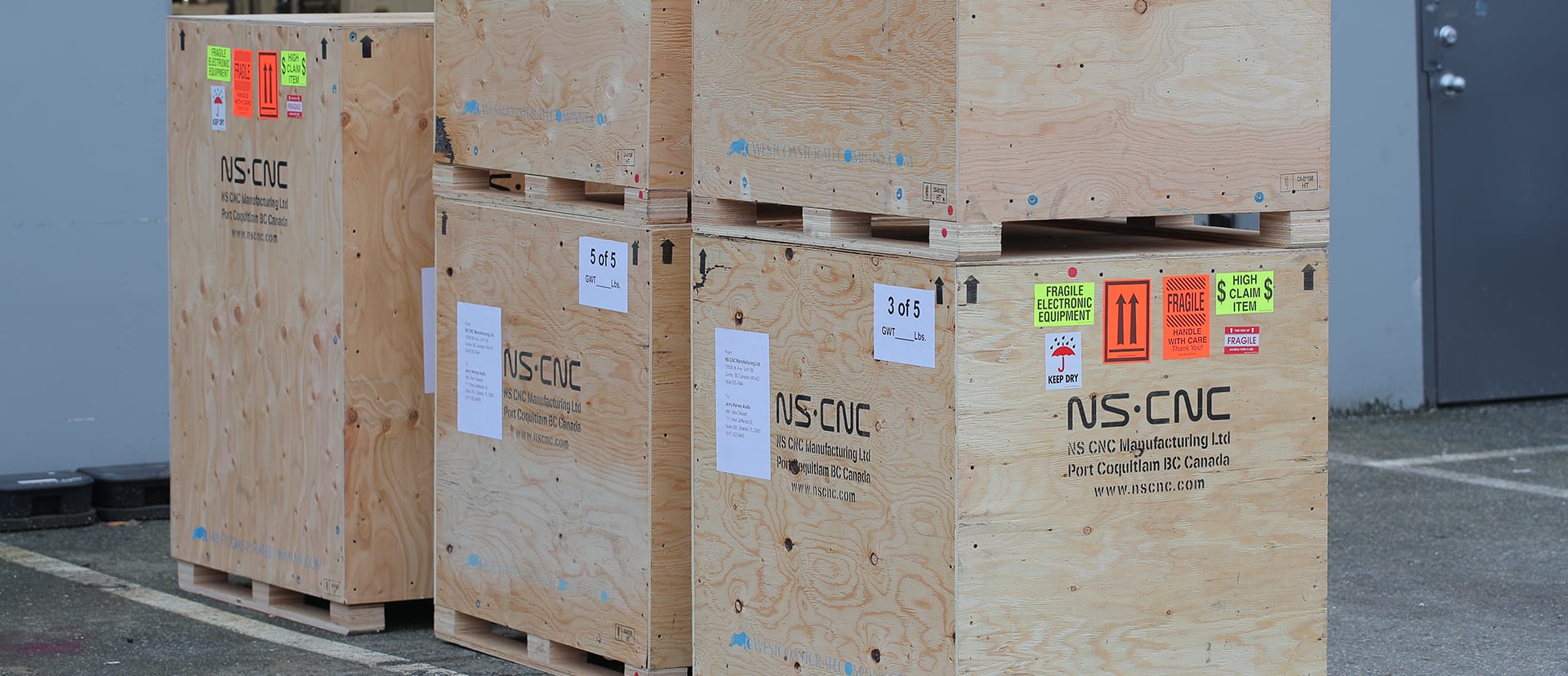 Plywood NS CNC shipping crates, stacked and labelled for delivery