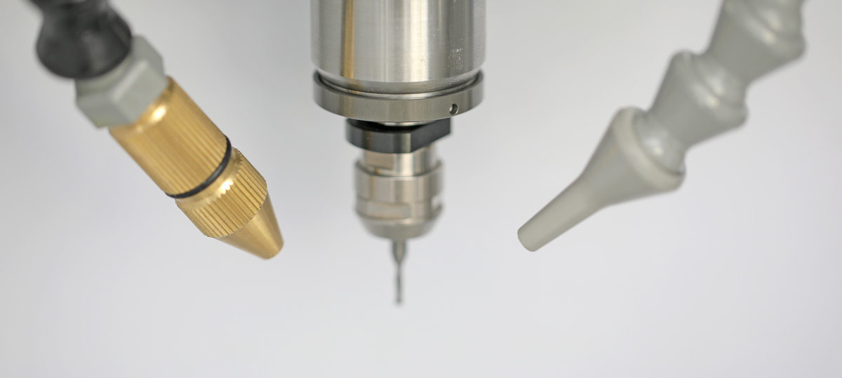 The coolant nozzle, spindle nose, and air nozzle converging on the cutting point