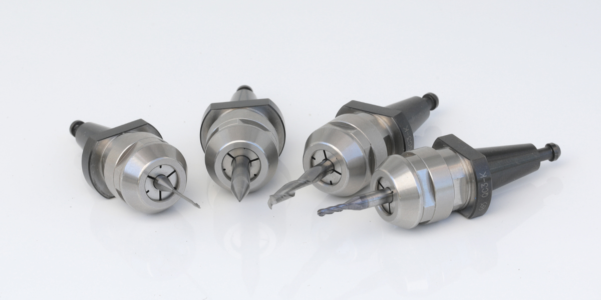 Four conical taper tool holders with different collets and tools